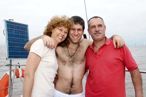 Happy family on board the yacht during a vacation — Stock Photo, Image