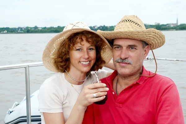 Elderly happy couple onboard the yacht