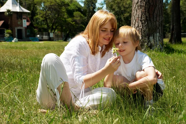 Mother and son on a glade near the house — Stock Photo, Image