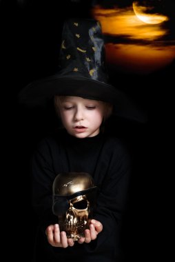 The small magician with a gold skull of dead pirate clipart