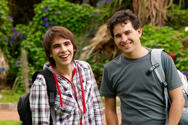 Portrait happy young students in park — Stock Photo, Image