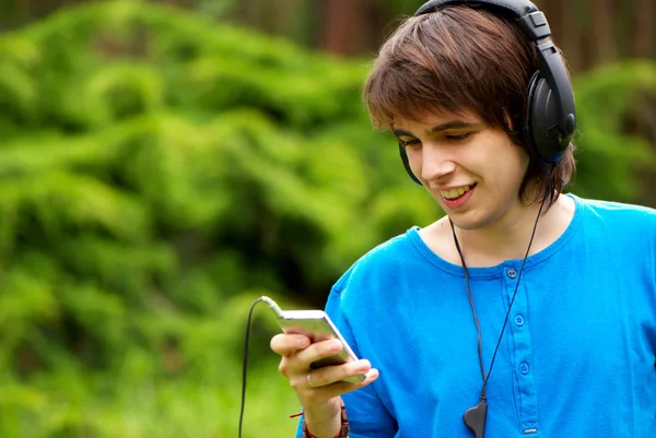 Šťastné dospívající chlapec v sluchátka — Stock fotografie