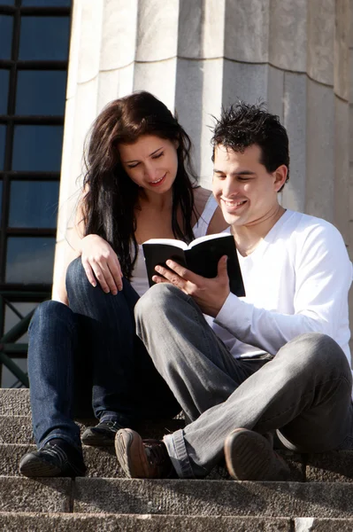Young couple of students with the book — Stock Photo, Image