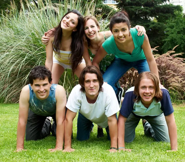 Happy group of friends outdoors in a park — Stock Photo, Image