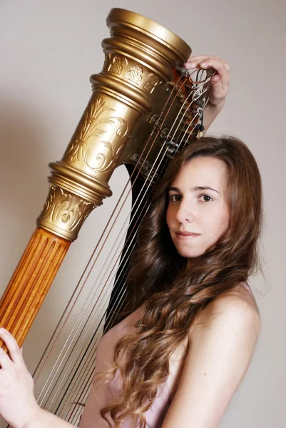 Female musician with harp — Stock Photo, Image