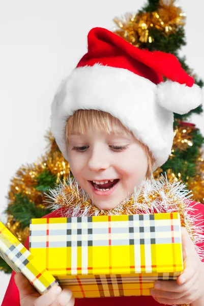 Small Santa Klaus with gifts in hands — Stock Photo, Image