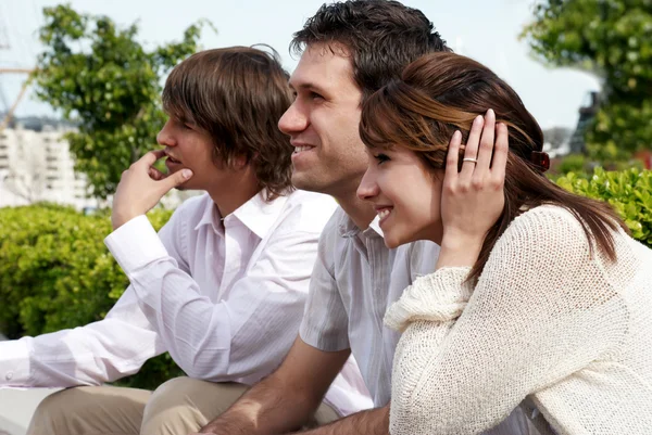 Group of young guys and girl sitting together — Stock Photo, Image