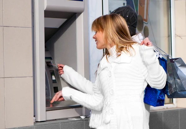 Glückliche Mädchen heben am Geldautomaten Geld von der Kreditkarte ab — Stockfoto