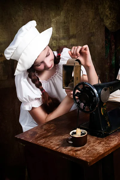 Portrait of a young seamstress with old lamp — Stock Photo, Image