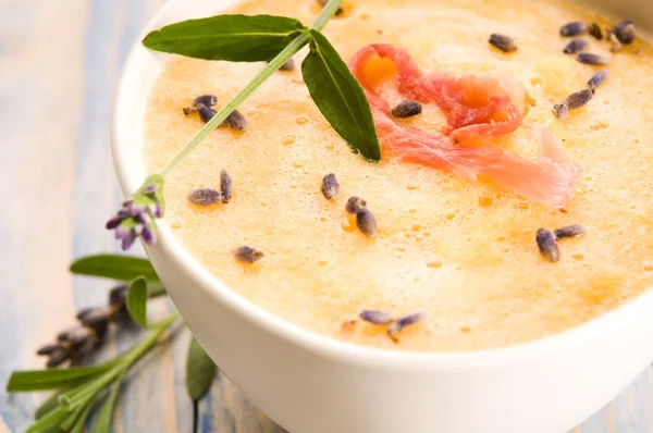 Свежий дынный суп с ветчиной пармы и цветком лаванды — стоковое фото