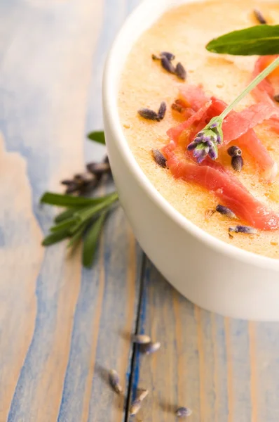 Fresh melon soup with parma ham and lavender flower — Stock Photo, Image