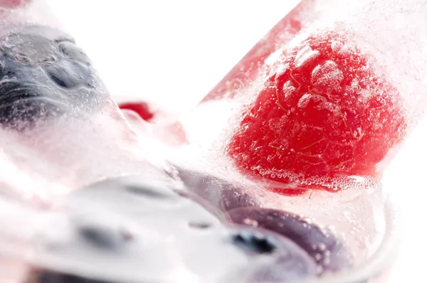 Raspberry and blackberry frozen in ice sticks — Stock Photo, Image