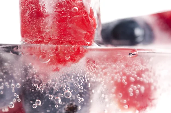 Raspberry and blackberry frozen in ice sticks — Stock Photo, Image
