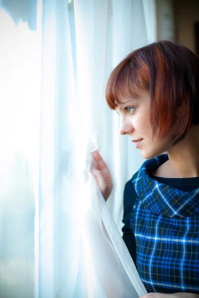 Woman Looking Through The Window — Stock Photo, Image