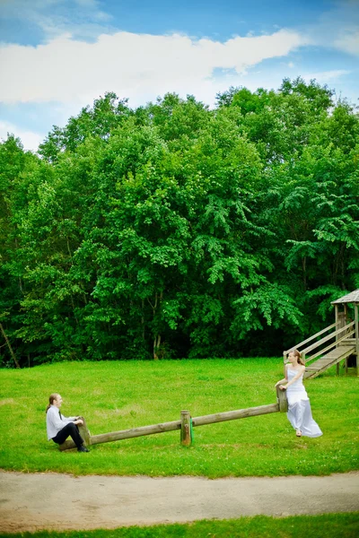 Bride, Groom And Seesaw — Stock Photo, Image