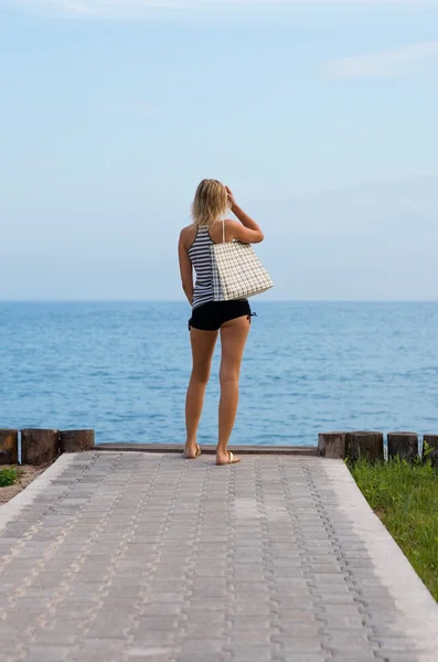 Atrakcyjna blondynka stoi przy plaży — Zdjęcie stockowe