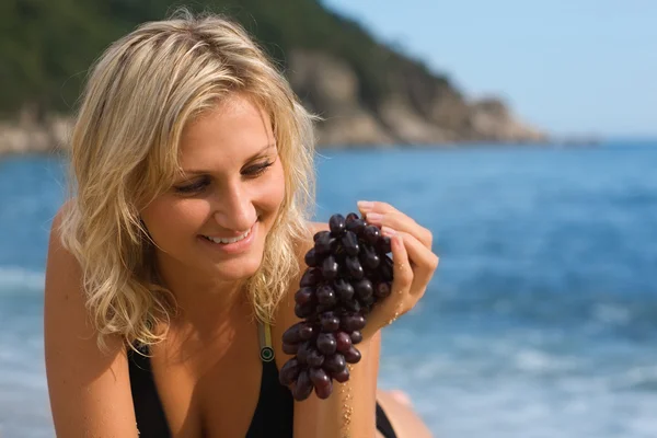Beautiful girl with grapes