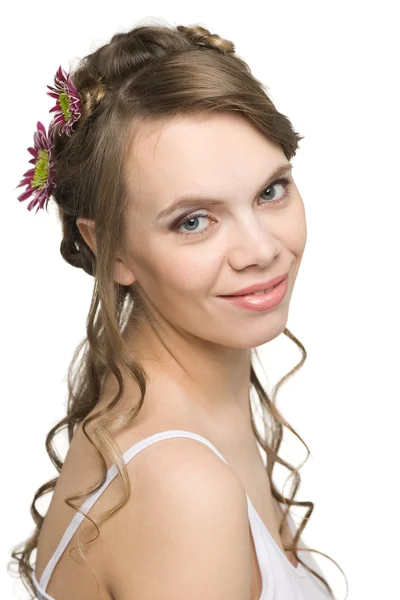 自分の髪に花を持つ少女の笑顔 — ストック写真