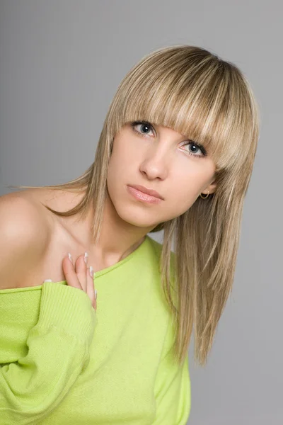 Attractive blonde girl with a fashionable hairdo — Stock Photo, Image