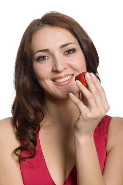 Young woman eating a fresh red stravberry. Stock Image