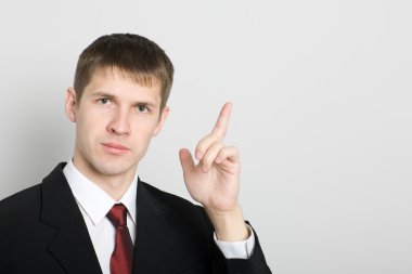 Businessman points his hand towards the. clipart