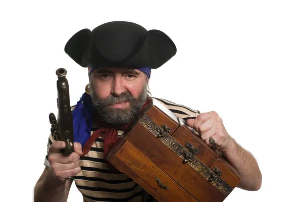 Pirate with a musket holding chest. — Stock Photo, Image