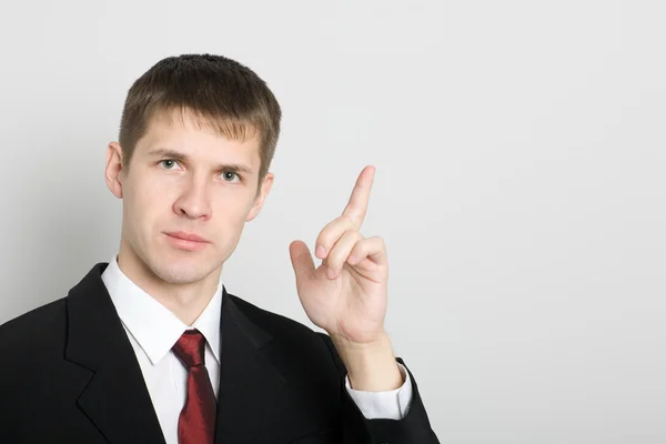 Businessman points his hand towards the. — Stock Photo, Image