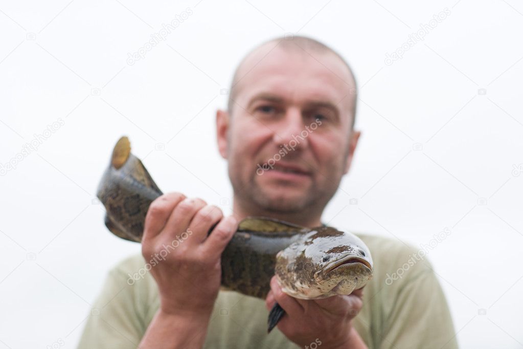 Fisherman holding a snakehead