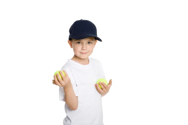 Usměvavý chlapec s tenisové míčky — Stock fotografie