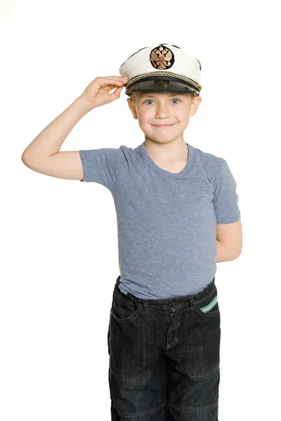 Junge mit Seemütze salutiert. Stockbild
