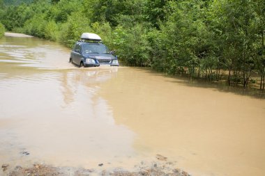 Car moved to wade stretch of road clipart