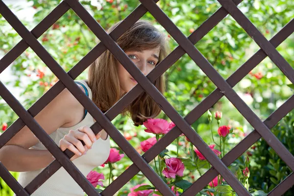 Tienermeisje achter een hek — Stockfoto