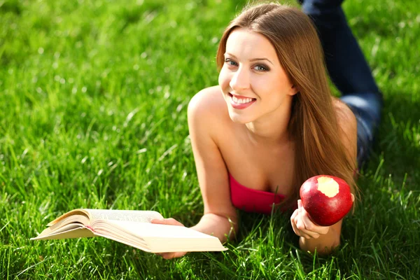 Woman in the park with book — Stock Photo, Image