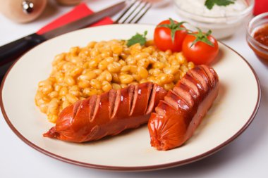 Fried sausages with white beans clipart