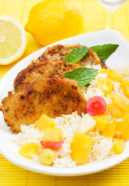 Carribean style pork loin chops with rice and tropical fruit — Stock Photo, Image