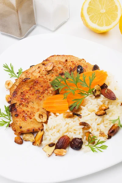 Asian style pork chops with rice and roasted nuts — Stock Photo, Image