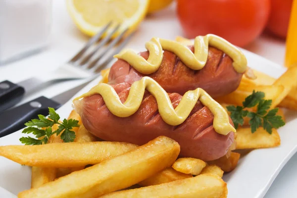 Grilled sausage with french fries — Stock Photo, Image
