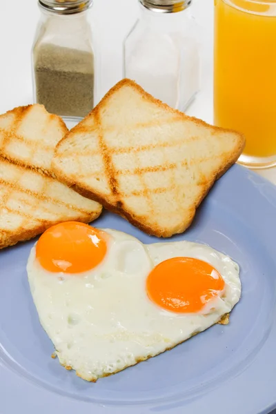 Heart shaped fried eggs — Stock Photo, Image