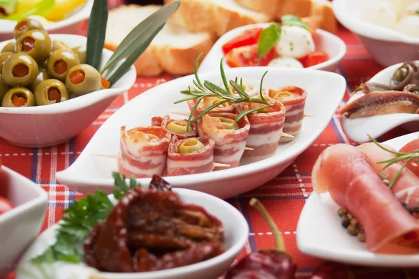 Bacon rolls and other antipasto food — Stock Photo, Image