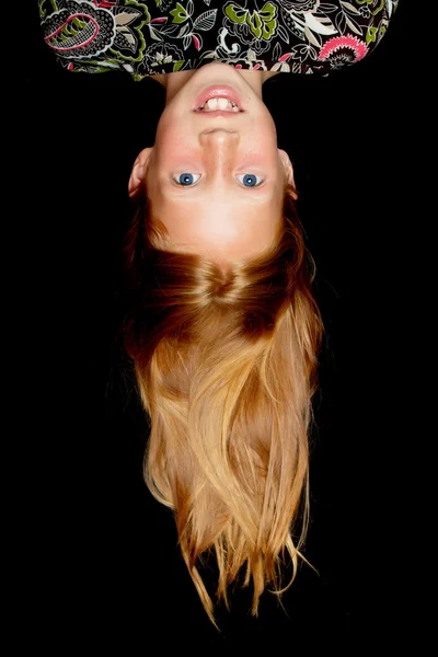 Young redhead girl hanging upside down — Stock Photo, Image