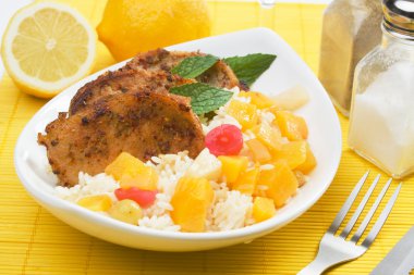 Pork loin chops with tropical fruit and cooked rice clipart