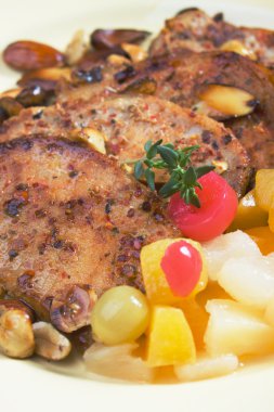 Caribbean style pork chops with tropical fruit clipart