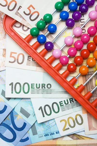 Colorful abacus and european money — Stock Photo, Image