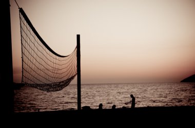 Volleyball net at sunset clipart