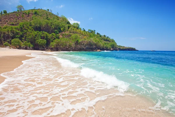 Vista desde una playa de arena sobre rocas en el océano. Indonesia, Bali — Foto de Stock