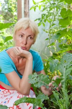 The young attractive woman is upset - caterpillars eat leaves of plants clipart