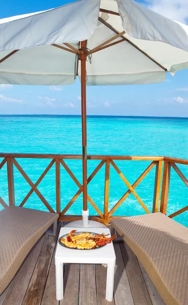 Plato con langosta en la mesa y vista al mar —  Fotos de Stock