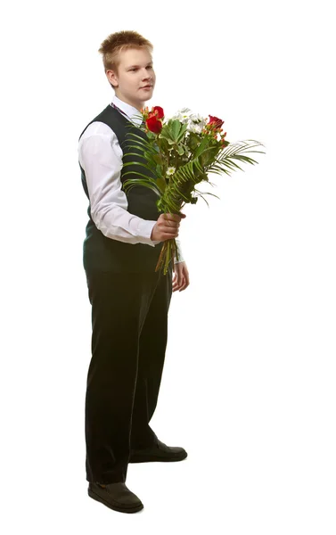 Der Schüler in der Schuluniform mit einem Blumenstrauß — Stockfoto
