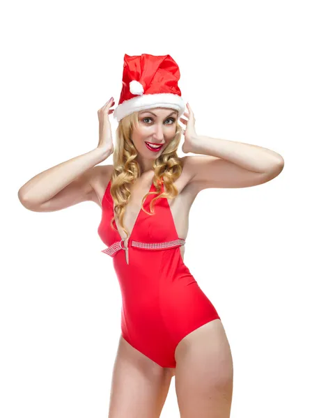 Blondin i en baddräkt och nyårsafton röd hatt — Stockfoto