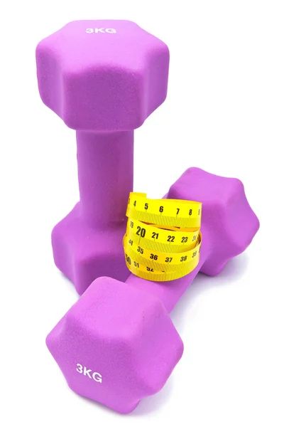 Measuring tape and and Pink dumbbells in a neoprene cover — Stock Photo, Image